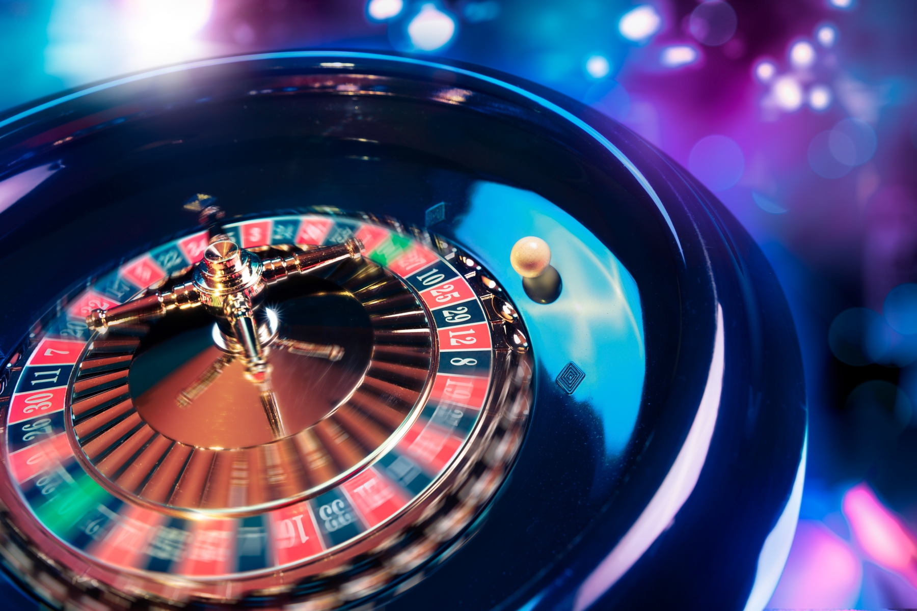 12823558-roulette-wheel-in-motion-with-a-bright-and-colorful-background